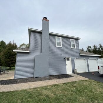 home and garage in Blue Bell, PA with new vinyl siding and chimney