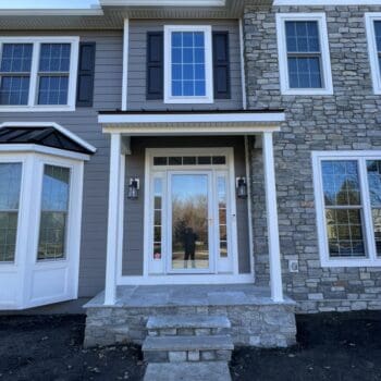 Front of a home with new gray Hardie siding and Provia windows