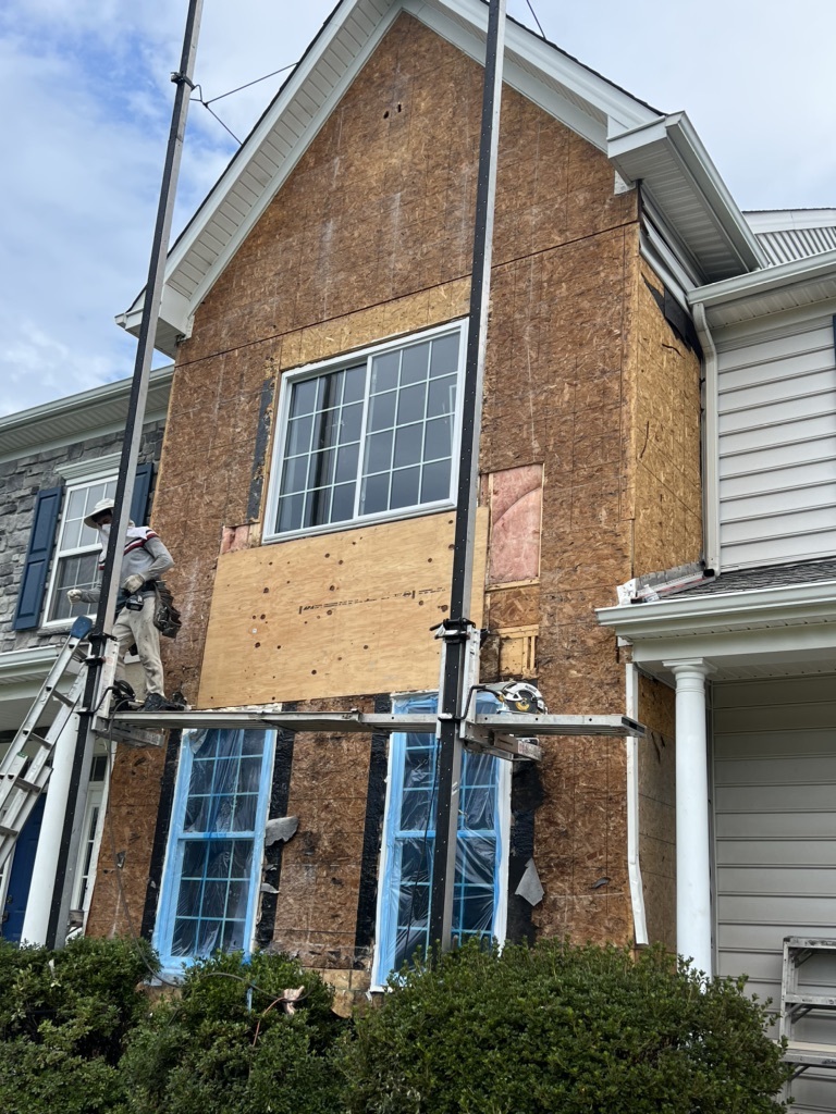 Before a Stucco to CertainTeed board & batten siding installation in Pottstown, PA -2