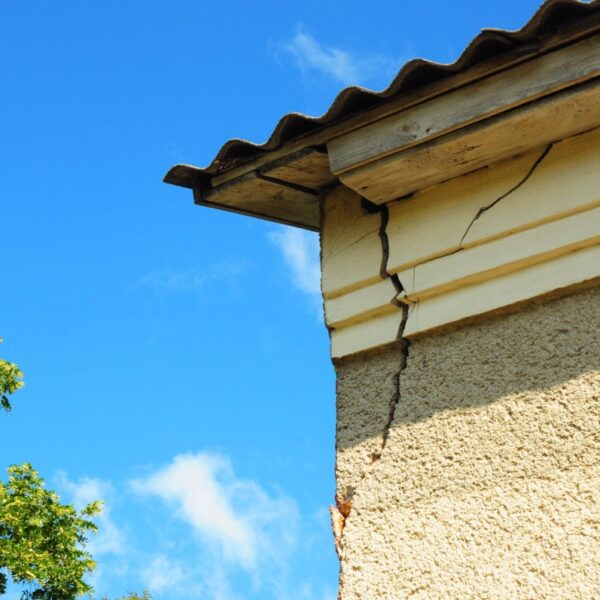 A crack on a stucco house near the roof